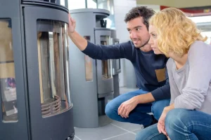 Lady and a Man Checking High Efficiency Furnace — Paducah, KY — Triangle Heating & Cooling