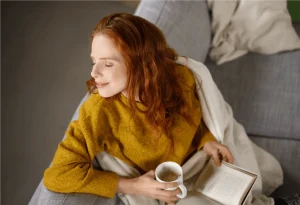 Woman Wearing Yellow Holding a Coffee Cup — Paducah, KY — Triangle Heating & Cooling